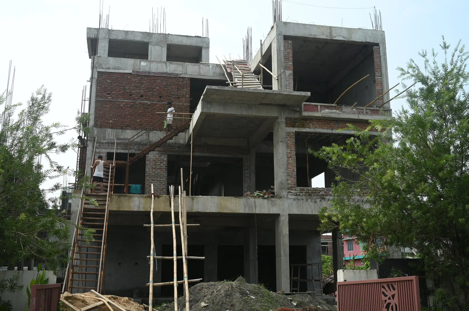 Sixmile residential building construction under progress with workers and formwork