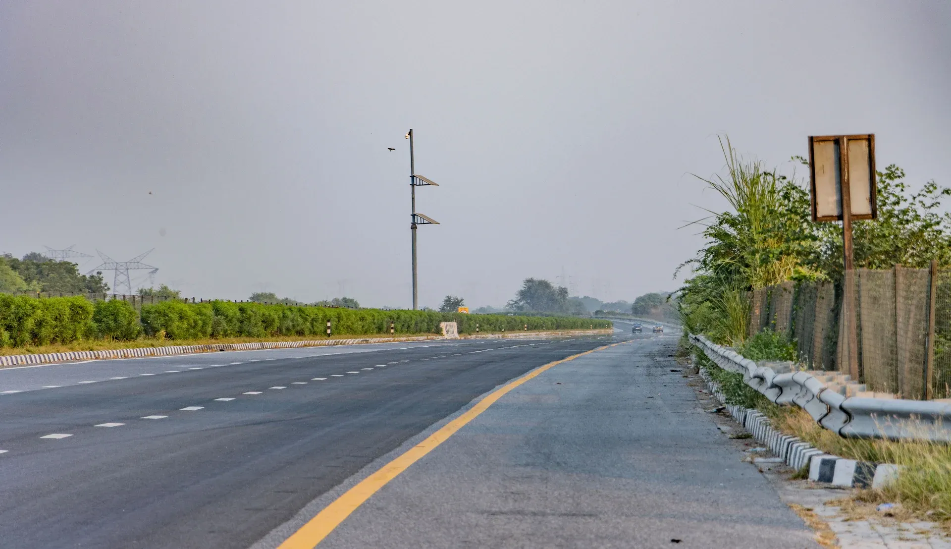Finished asphalt highway corridor with drainage structures and road markings